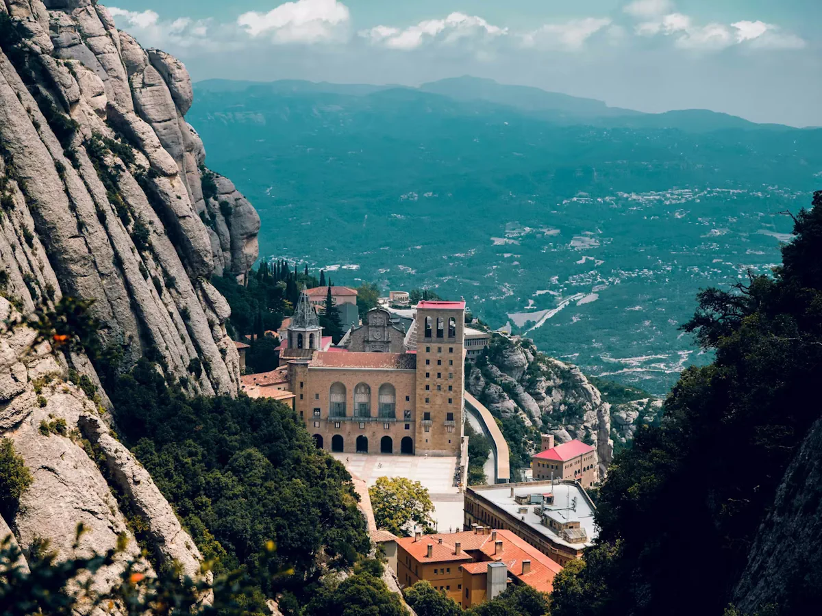 Exterior of Montserrat Monastery beneath the distinctive rock formations in Catalonia, Spain