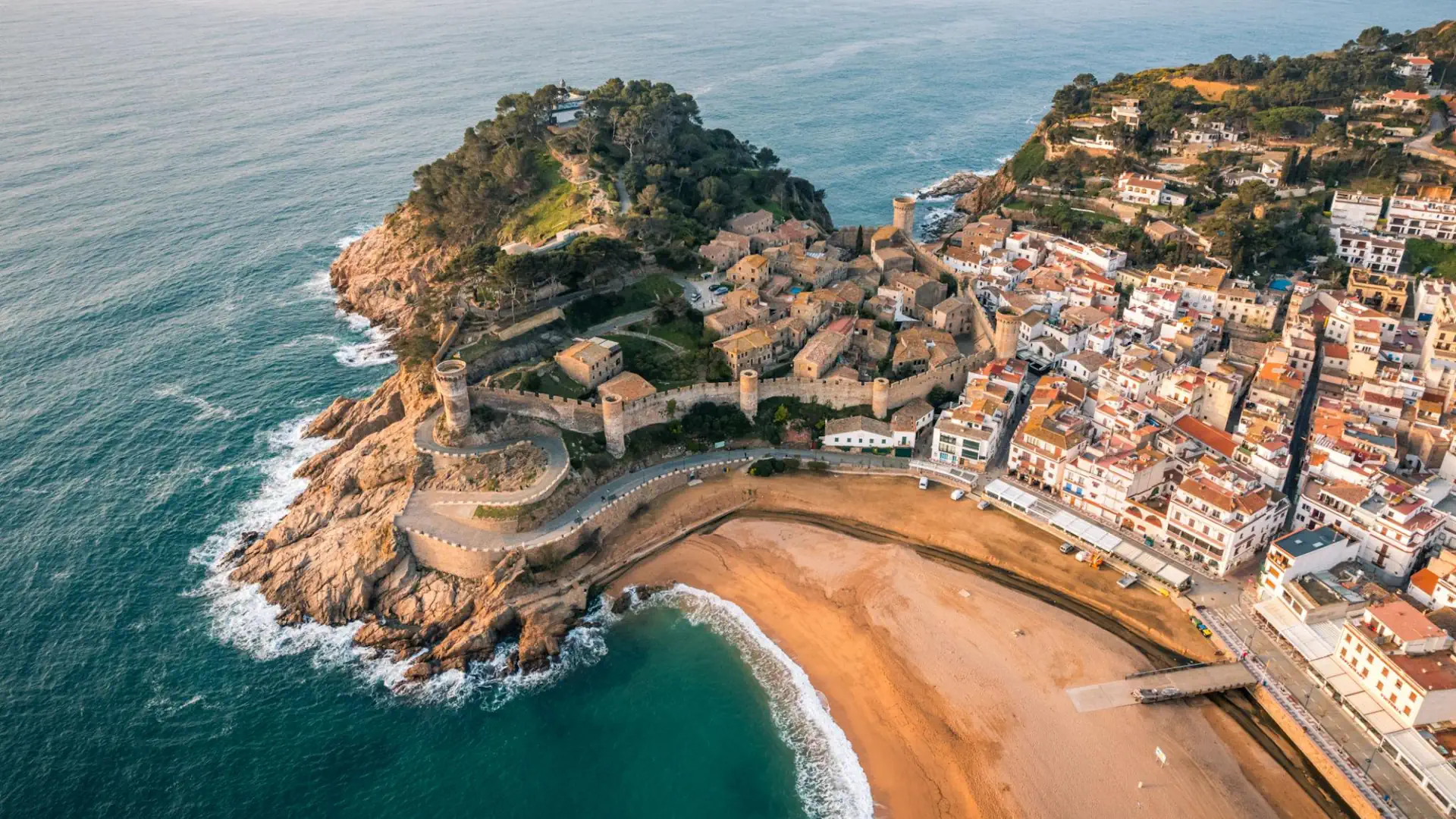 View of the medieval fortress and coastline of Tossa de Mar during a Costa Brava day trip from Barcelona