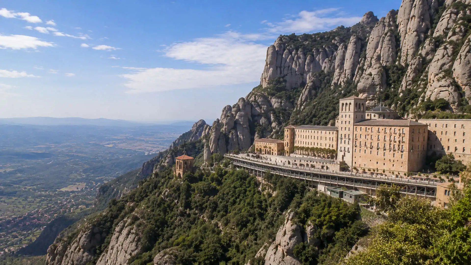 Montserrat monastery surrounded by mountain formations at sunrise