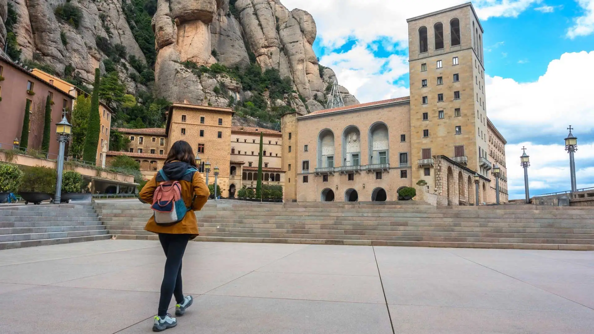 Visitors walking through the main square at Montserrat monastery